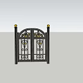 Black Wrought Iron Entrance Gate With Golden Finials And Intricate Patterns