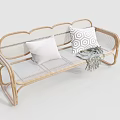 Stylish Outdoor Rattan Bench With Plain And Geometric Pattern Cushions And Woven Blanket
