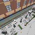 Vibrant Commercial Street With Red Roof Buildings Shops Outdoor Seating Green Plants And String Lights