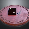 Round Red Wooden Table Top With Black Notebook Pen And USB Drive