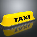 Yellow Taxi Roof Sign with Black TAXI Lettering and Reflection Effect on Dark Background