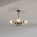 Brass Chandelier With White Spherical Lampshades On White Ceiling With Circular Plaster Moldings And Trim
