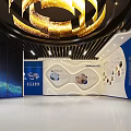 Innovative Exhibition Space With Large LED Screen And Golden Circular Lighting Design