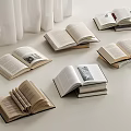 Open Books Scattered on White Table with White Curtains in Background