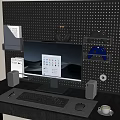Modern Computer Desk Setup With Monitor Keyboard Mouse Headphones Game Controllers On Perforated Wall