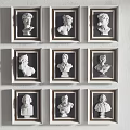 White Bust Portrait Paintings in Golden Frames Arranged in Grid on Wall