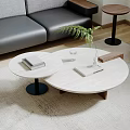 Modern Round Coffee Table With White Marble Top Black Base Green Plant Books And Glass