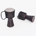 Two Handmade Dark Brown Drums with Carved Patterns and White Drumheads Standing and Lying