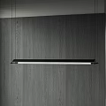 Modern Linear Pendant Light Hanging Over Dark Wooden Wall With Adjacent Window Blinds