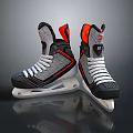 Black Gray Ice Hockey Skates With Orange Accents White Laces And Steel Blades