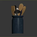 Blue Ceramic Jar With Various Kitchen Utensils Including Black And Wooden Tools