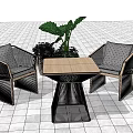 Two Woven Leisure Chairs With Square Wooden Table And Green Plants On Tile Floor