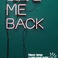 Pink Decorative Neon Light with ME BACK Lettering on Green Background and Wires