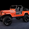 Orange Jeep Open Top Convertible With Large Off Road Tires And Gray Seats