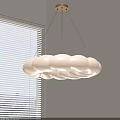 Soft Cloud Shaped Pendant Light Hanging In Interior With Window Blinds And Light Colored Walls