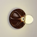 Wooden Wall Lamp With Circular Base And Glass Globe Shade Emitting Warm Light