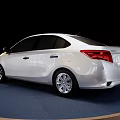 Elegant White Toyota Sedan Showcased On Round Blue Display Platform