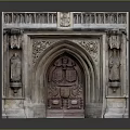 Gothic Architectural Carved Entrance With Arched Design And Stone Side Statues
