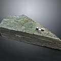 Stacked Natural Stone Slabs With Green Gray Textured Surface And Top Marker