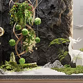 Whimsical Garden Decor With Hanging Plants Spherical Greenery Deer Sculpture And Mossy Sand Scene