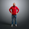 Man In Red Hoodie And Blue Jeans Standing With Hands On Hips Against Gray Background