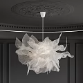 Elegant White Flower Shaped Chandelier In Modern Interior With Dark Walls And Decorative Ceiling