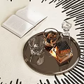 Elegant Barware Set With Decanter Glasses On Metal Tray And Open Book