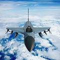 Modern Fighter Jet Flying Over Clouds With Missiles And Military Insignia