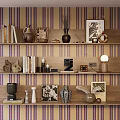 Sculpture Carvings Displayed On Wooden Shelves With Striped Wallpaper And Decorative Items