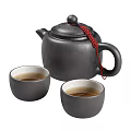 Black Tea Set with Red Tassel Decorated Teapot and Two Black Teacups Filled With Tea
