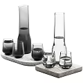 Modern Glass Tea Set With Grey Transparent Bottles Cups On Textured Concrete Trays