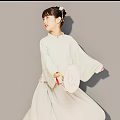 Woman in Traditional Hanfu Holding Decorative Hand Fan Against Gray Background