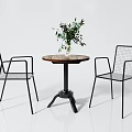 Modern Round Wooden Table With Black Metal Wire Mesh Chairs And Green Plant