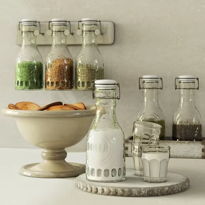 Glass Spice Jars With Various Spices On Kitchen Countertop Alongside Bowl And Glass Cups 3d model