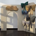Beige Arched Storefront With Wooden Plaque and Multiple Colored Bows Green Blue Gold Gray Silver