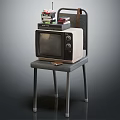 Vintage Television Placed On Metal Chair With Stacked Items On Top