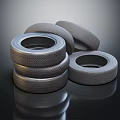 Stacked Car Tires Display With Shiny Surface And Textured Design Details