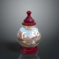 Transparent Glass Jar With Red Lid And Smooth Reflective Body On Base