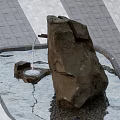 Garden Landscape with Natural Rock Fountain and Flowing Water in Pool