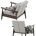 Cozy Gray Armchair With Wooden Frame Pillows And Pom Pom Blanket
