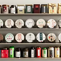 Colorful Tea Sets Displayed on Shelves with Assorted Tea Cans and Round Cakes 3d model