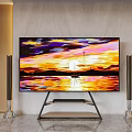 TV on Modern Stand Showing Sunset Landscape with Floor Speakers and Marble Wall