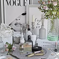 Perfume And Cosmetics Display With Vogue Magazine Floral Bouquet And Scented Candles