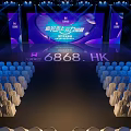Stunning Stage Design With Blue Lighting Arranged Seats And Backdrop Screens