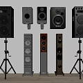 Various Styles of Audio Speakers Including Floor Standing and Bookshelf in Different Colors on Stands