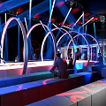 Tobacco and Liquor Store Interior With Arched Structures Colorful Lighting and Customers