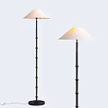 Two Modern Floor Lamps With Black Metal Poles And White Conical Shades