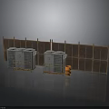 Gray Industrial Units With Yellow Safety Rails And Wooden Fence Panels Plus Orange Barrel