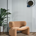 Modern Tan Accent Chair With Unique Curved Shape Vertical Striped Wall And Green Plant