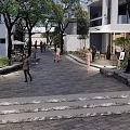 Commercial Landscape With Pedestrian Walkway Stone Pavement Trees White Buildings And Outdoor Seating